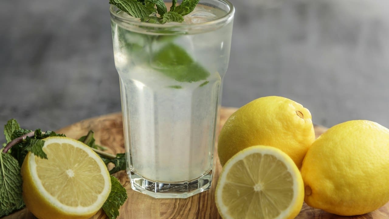 Bardakta limonata ve dilimlenmiş misket limonları