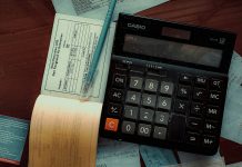 Geç ödemeler ve nakit akışı: Ahşap masa üzerinde hesap makinesi